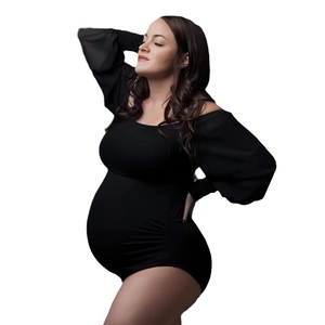 Sleek black long sleeve maternity bodysuit in stretchy fabric for photo shoots