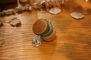 Detail of vintage round leather measuring tape case with embossed floral pattern