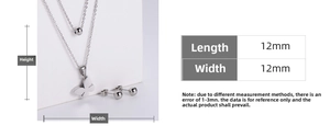 Macro detail of silver butterfly pendant and ball studs with size measurements in mm