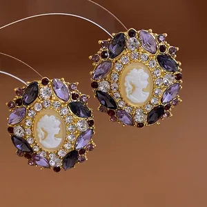 French vintage relief portrait earrings with purple rhinestones on a gold base