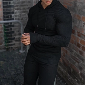 Detail of black vertical ribbed knit fabric on a slim fit men's athletic hoodie
