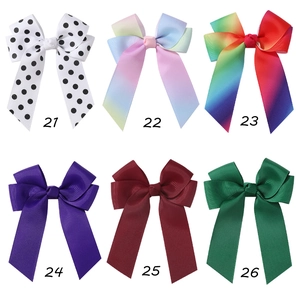 Detail of six colorful grosgrain ribbon hair bows for girls in polka dots and gradients