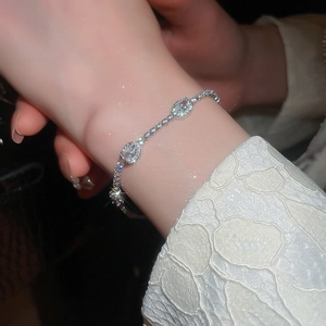 Detail view of silver adjustable bracelet featuring oval cubic zirconia and pave stones