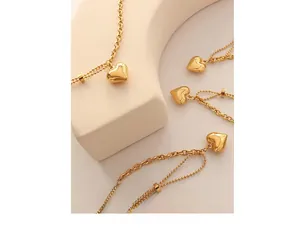 Macro shot of 3D heart pendant with double-layered gold-plated chains on display