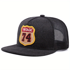 Charcoal grey vintage trucker hat with mesh back and embroidered VINTAGE 74 shield patch