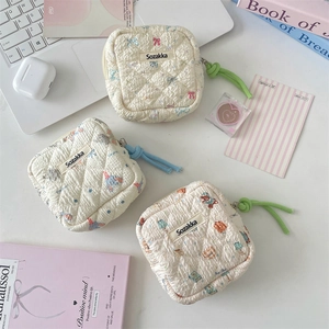 Detailed view of quilted cotton storage bags with cute cartoon prints and zip closure