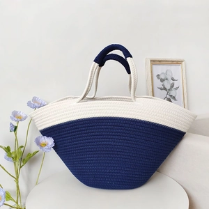 Large blue and white cotton rope woven tote bag on white table with elegant decor