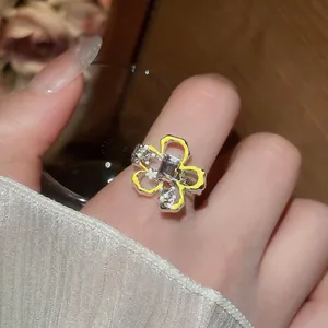 Anello aperto floreale con pietra viola centrale e dettagli in smalto giallo