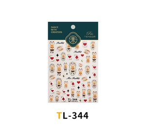 Detail of vintage French rabbit nail stickers with poker card symbols and gold accents