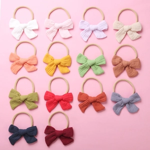 Detailed collection of 14 colorful cotton muslin bow headbands for baby girls