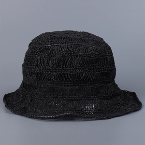 Close-up view of a chic handmade black hollow woven straw bucket hat for women