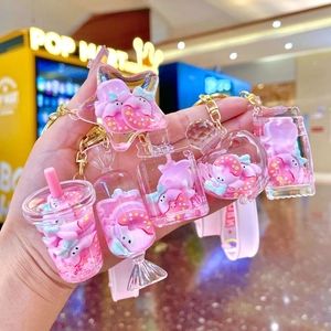 Pink donut liquid sand acrylic keychain set featuring cute cartoon characters and charms