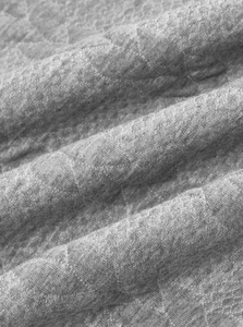 Close-up of grey knit fabric texture showing the soft ribbed jacquard material details