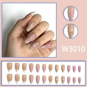 Long stiletto press-on nails with white gradient, 3D floral accents, and star patterns