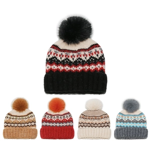 Detail showing five Fair Isle knit beanies with large pom-poms in various retro colors