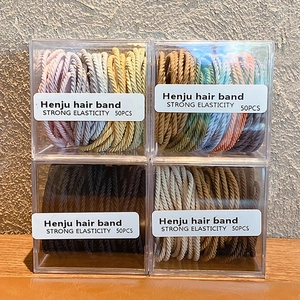 Quatre boîtes d'élastiques à cheveux haute élasticité en couleurs noir et marron