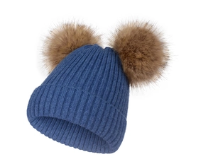 Gros plan détaillé d'un bonnet d'hiver en tricot bleu avec deux pompons en fourrure brune