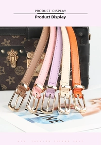 Detail view of five assorted colorful slim PU leather belts with gold buckles and chic style