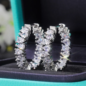 Macro view of pear-cut AAA cubic zirconia stones on silver luxury hoop earrings