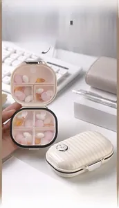 Detail view of mini portable pill box with 4 compartments and secure metal buckle