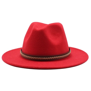 Close-up of bright red wool jazz hat featuring a brown braided leather band detail