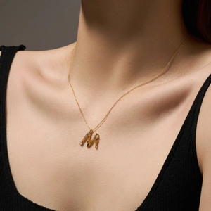 S925 sterling silver golden letter M necklace with colorful zirconia on a model