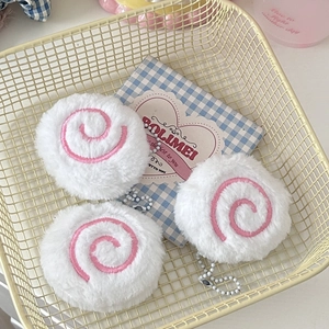 Three cute narutomaki plush pendants with pink spirals and white bead chains in a basket