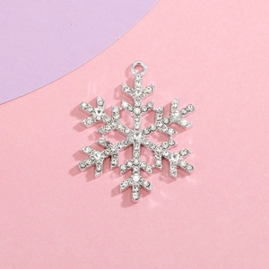 Macro detail of silver snowflake pendant with sparkling rhinestones for DIY jewelry