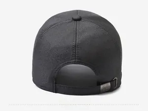 Detail of adjustable metal buckle and stitching on the back of black baseball cap