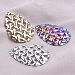 Detailed view of woven metal teardrop charms in gold, silver, and rainbow finishes