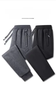 Detailed view of high-quality knitted jogger pants with elastic cuffs and zippered pockets