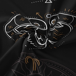 Detailed macro view of black bohemian tapestry fabric with gold and white celestial print