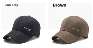 Close-up of dark grey and brown sport caps with embroidered lettering in twill fabric