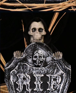 Halloween prop featuring a grim reaper rising behind a RIP tombstone with lighting