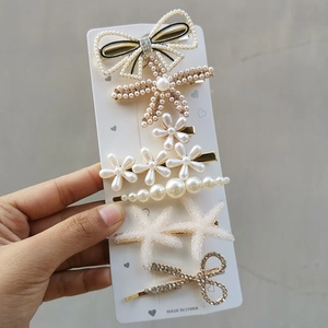 Detailed macro of candy-colored hair clip set with pearls and rhinestones