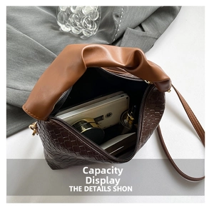 Detail of spacious dark brown croc-pattern bag interior with stylish pleated handle
