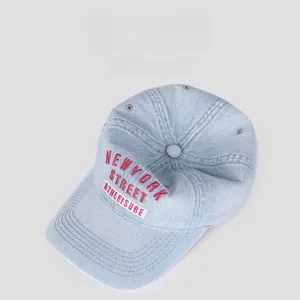 Detail of light blue denim baseball cap featuring red NEW YORK STREET embroidery