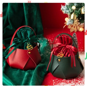 Detail of red and green leather Christmas gift bags with velvet drawstring and gold charm