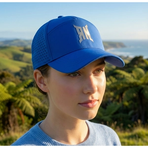 Detail view of royal blue baseball cap with RN logo and laser-cut ventilation holes