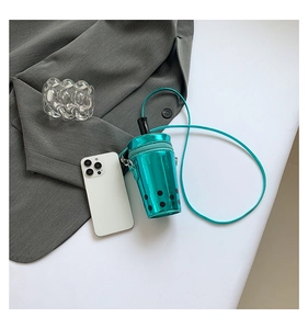 Close-up of metallic teal bubble tea cup crossbody bag with laser finish and black straw