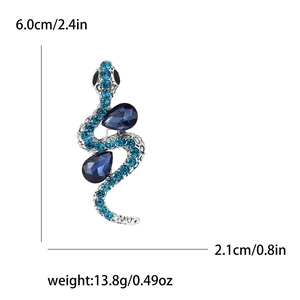 Retro silver snake brooch with blue rhinestones and crystals on a white background