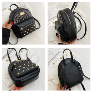 Detail view of black mini rivet backpack showing golden studs and front zipper pocket