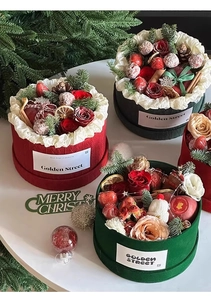 Detailed Christmas round gift box with red roses, strawberries, pine cones and cinnamon sticks