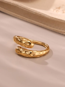 Macro shot of 18K gold-plated hammered open ring with organic wave texture