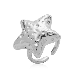 Macro detail of silver starfish ring featuring hammered texture and adjustable open band