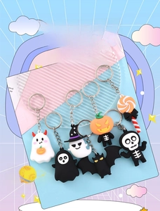 Close-up of 7 Halloween keychains featuring ghost pumpkin bat and skull designs