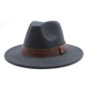 Detail of wool fedora hat with a classic brown leather band and wide flat brim