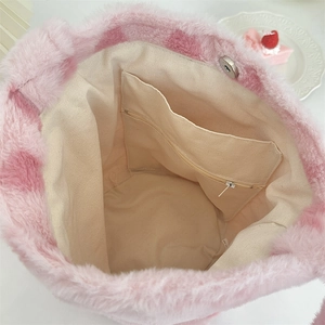 Top view of pink plush handbag interior featuring canvas lining and zipper pocket