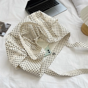 Detailed interior of polka dot canvas tote with lace trim and magnetic closure
