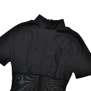 Detail shot of the black high neck short sleeve top showing sheer mesh patchwork and zipper